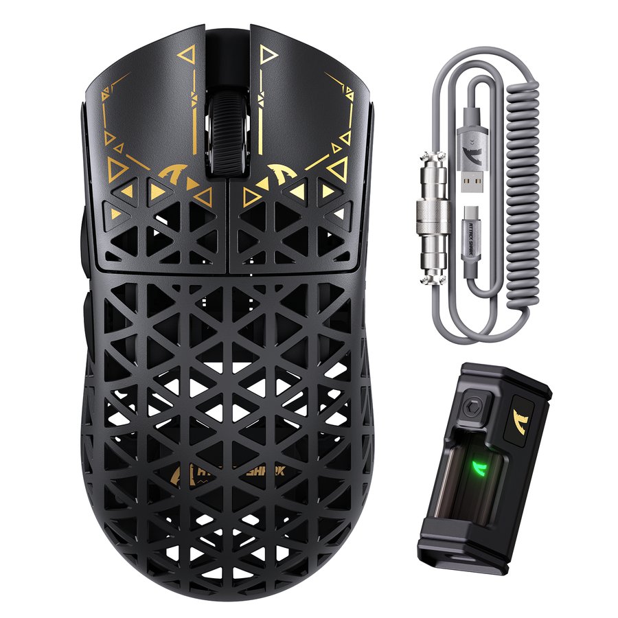 Lightweight wireless gaming mouse with its coiled cable arranged on a clean gaming desk.