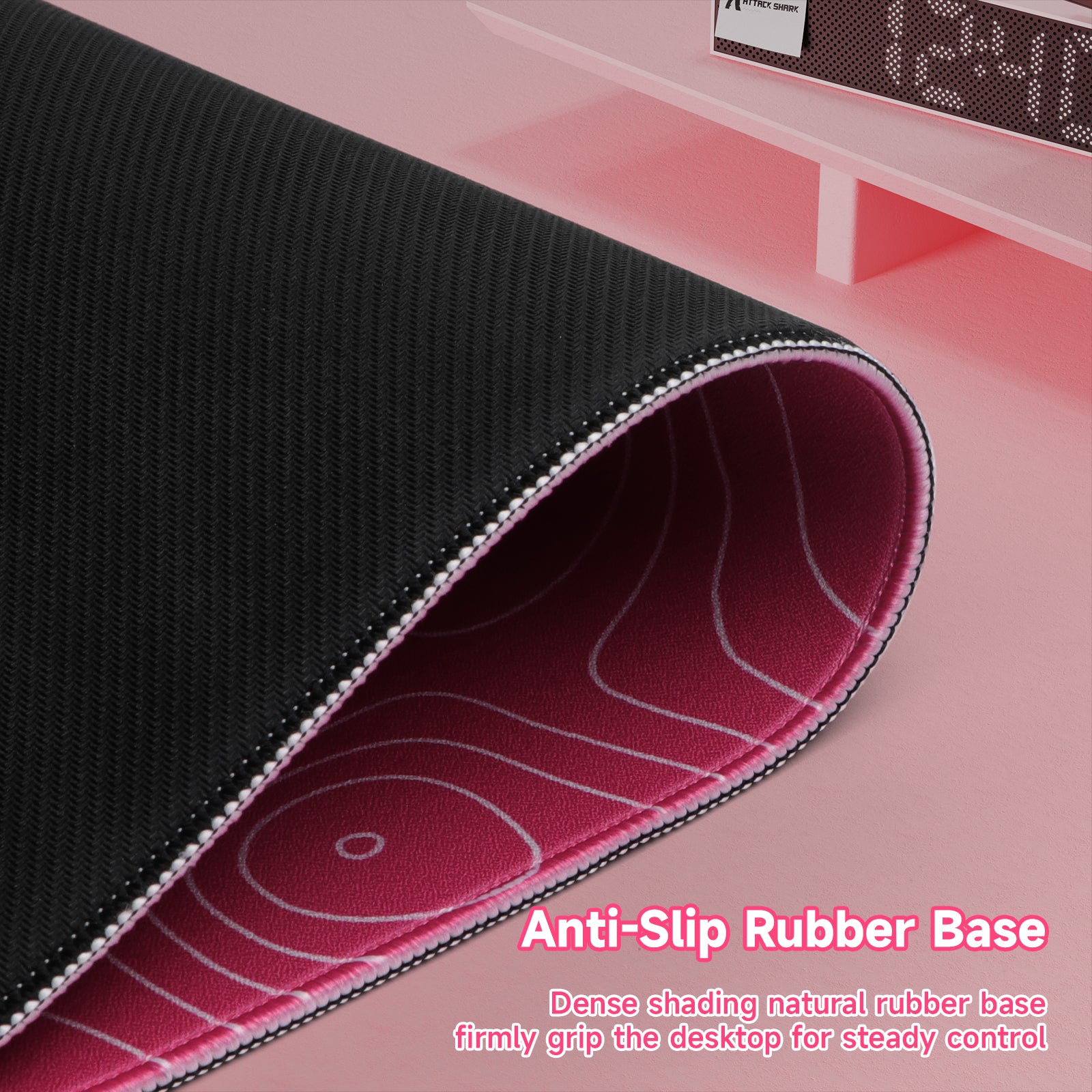 Black gaming mousepad with stitched edges and anti-slip rubber base, pink underside